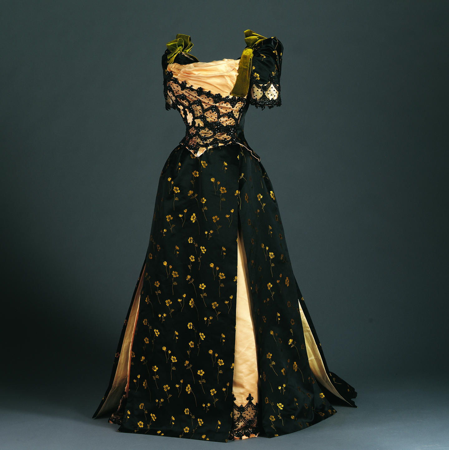 Miss Foley, Black satin brocade bodice with yellow flowers and green velvet bows, c. 1890. Brocaded silk satin, cotton net, and beads. Gift of Mrs. Theodore P. Grosvenor.