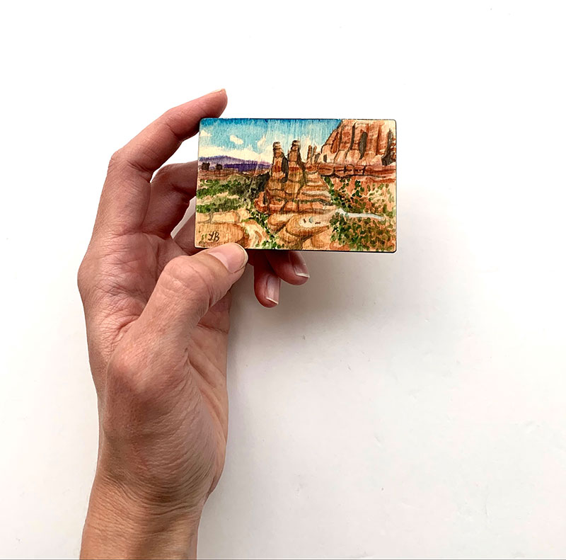 Lora Barnhiser, @Desert Oasis, 2020. Watercolor on rescued wood. Image courtesy of the artist.