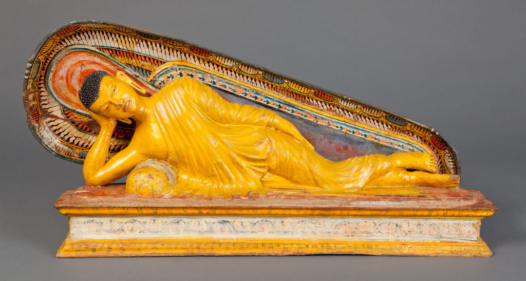 Unknown, Reclining Buddha (Buda reclinado), Kandyan period, 18th century. Wood, plaster and pigment. Gift of Barry Fernando MD and Coleene Fernando MD. Photo by Ken Howie.