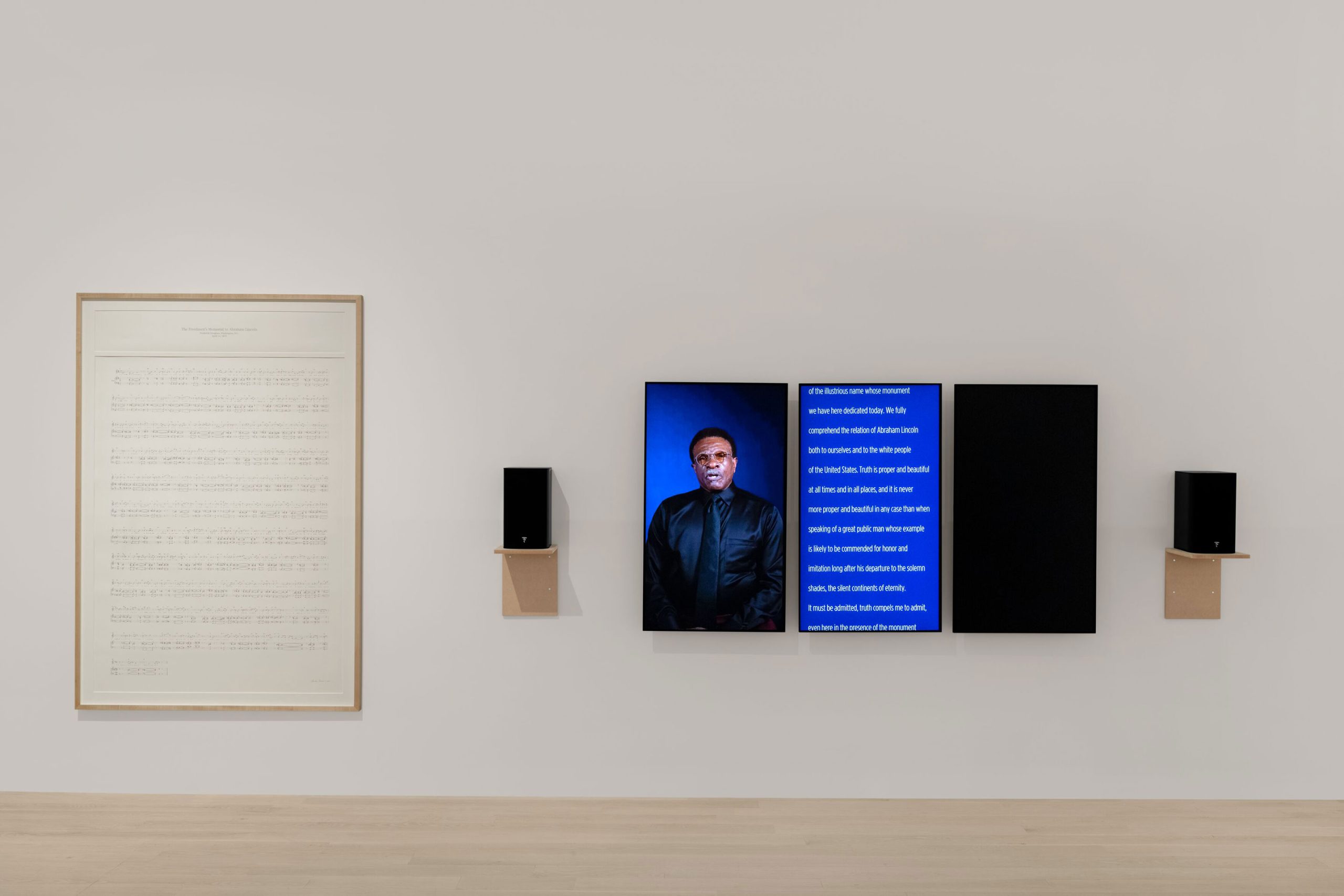 Charles Gaines, Manifestos 5, 2023. Three-channel video (color, sound, 5 minutes 24 seconds). One graphite drawing on paper, three monitors, two speakers, two hanging speaker shelves. Unique. Installation dimensions variable. © Charles Gaines. Courtesy the artist and Hauser & Wirth. Photo: Zachary Balber.